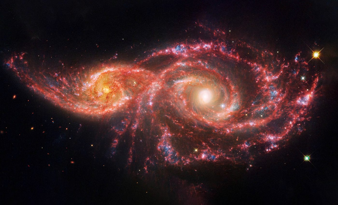 Dancing galaxies resemble bloodshot demon eyes on a black cosmic tapestry